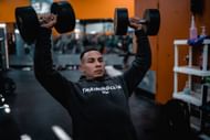 Triceps press builds bigger arms. (Photo via Unsplash/Ryan Hoffman)